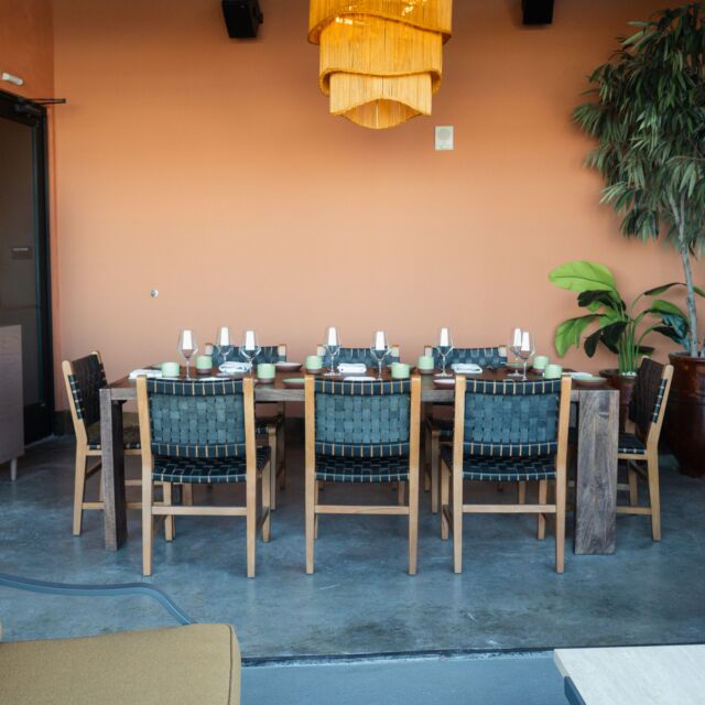 a dining area with a table and chairs set for a meal