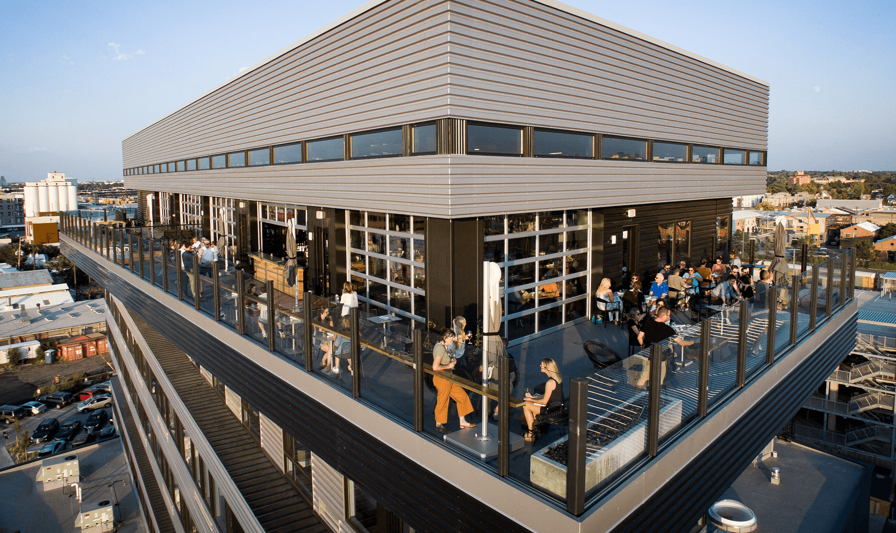 A rooftop bar with a modern building and city view